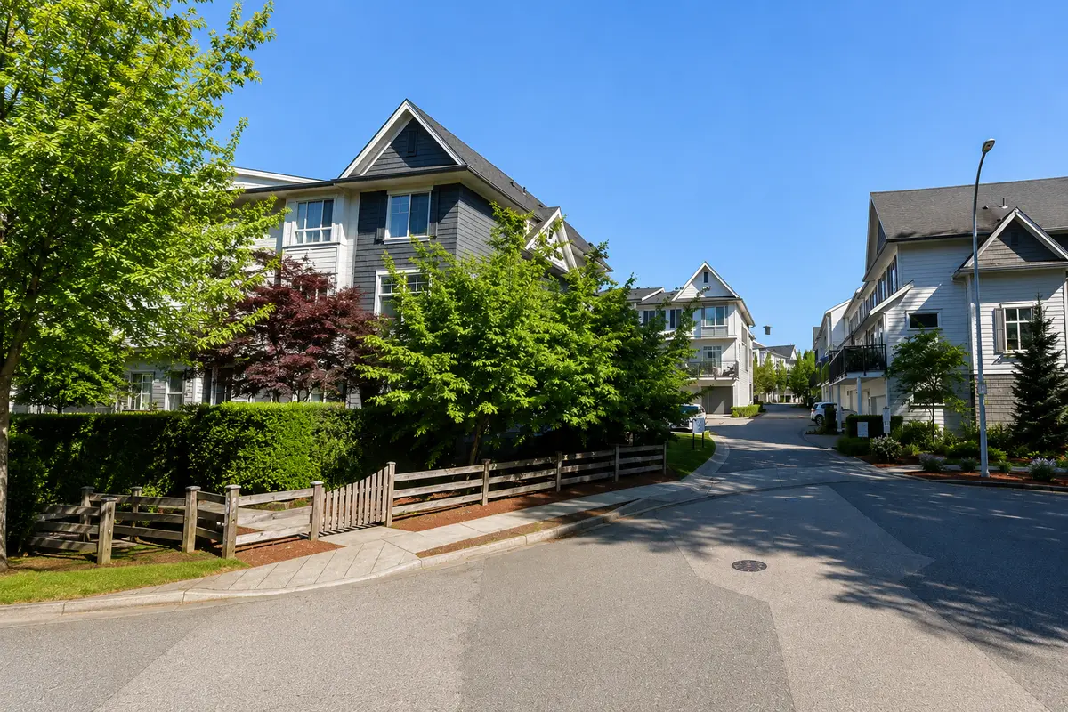 Street-level view of Guildford The Great townhomes in Surrey showing residential buildings, landscaped greenery, and internal roadway
