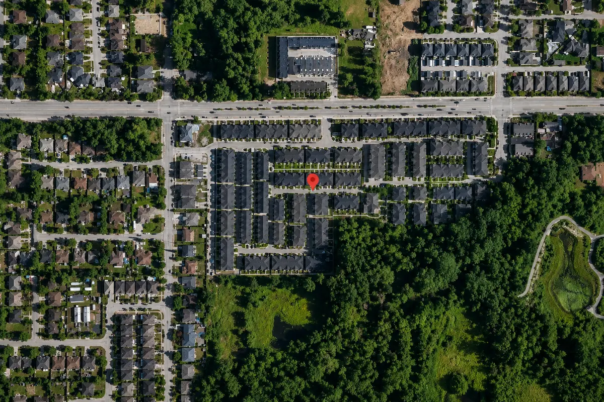 Aerial map of Panorama West Coast Living townhomes at 13898 64 Avenue in Newton, Surrey BC, showing the townhouse community, surrounding residential neighbourhood, nearby green space, and road network without map labels or business names.