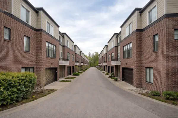 The Woods townhomes in South Surrey featuring modern brick and siding exteriors with a symmetrical street view and attached garages