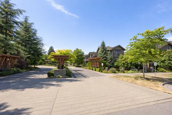 Wills Creek townhomes in South Surrey featuring landscaped entrance, craftsman-style homes, and tree-lined community setting