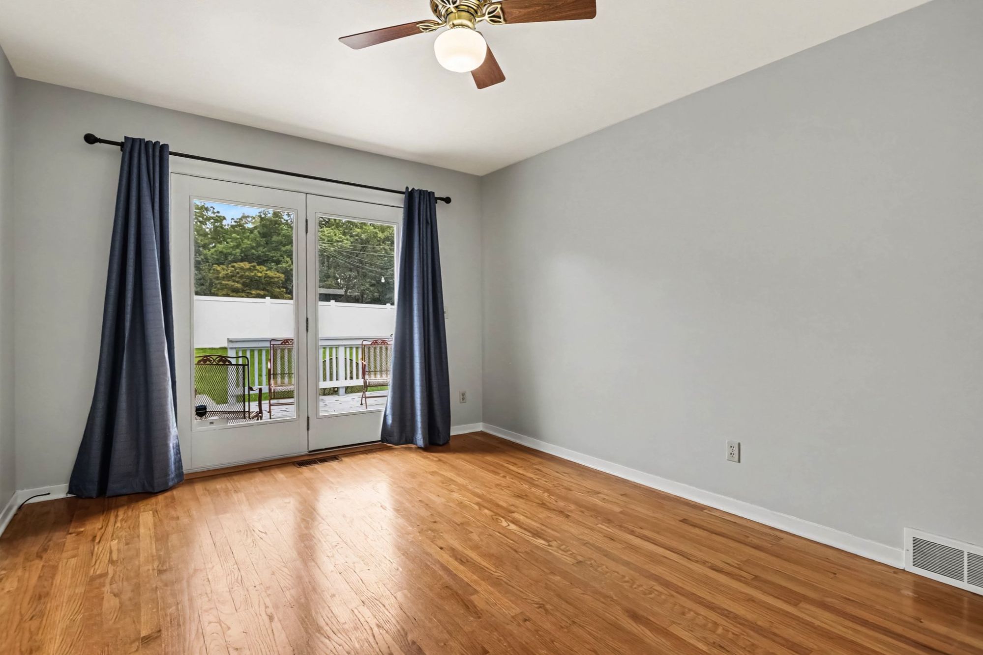 Family room with sliding door to deck and fenced backyard