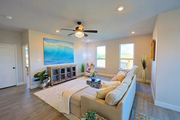 Living room with large windows to the back yard and to enjoy the sunrise view at 2415 Beverly Dr Granbury Texas