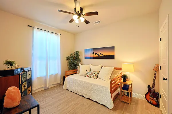 Guest Bedroom with ceiling fan and natural colors