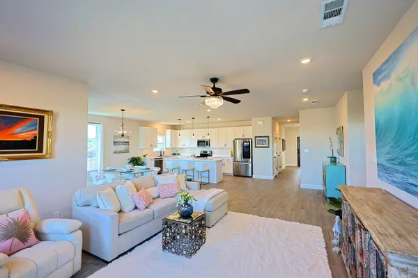 Open living room to kitchen with view of the front door hall at 2415 Beverly Dr, Granbury, TX 76048-6473