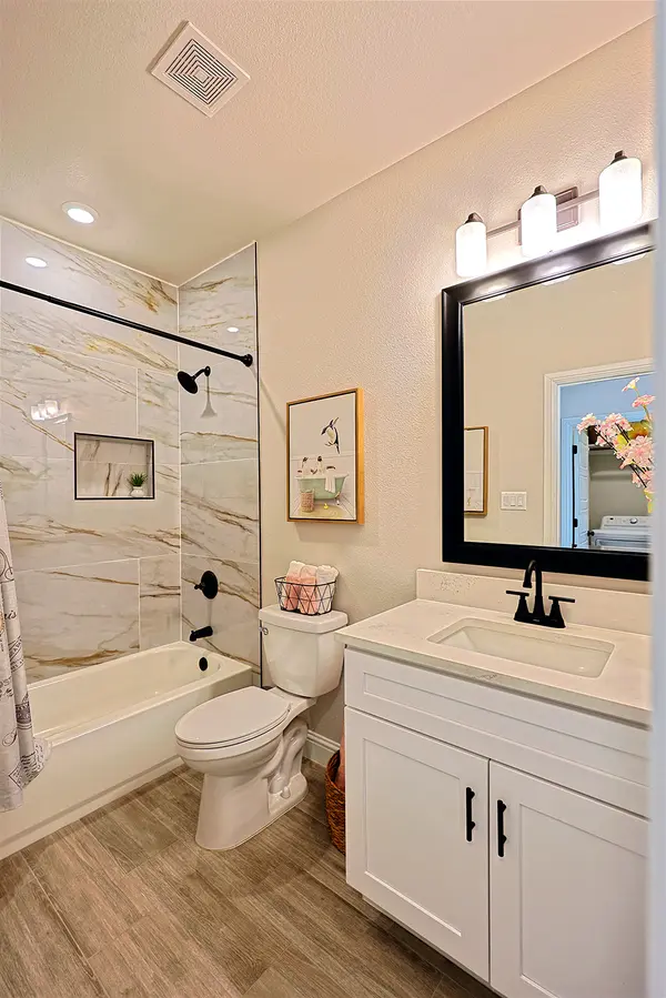 Guest Bathroom with brown accent tile and matte black finishes