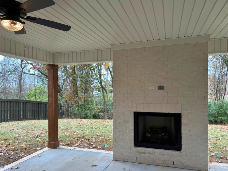 Cozy outdoor patio with fireplace by LeeHouse Homebuilders