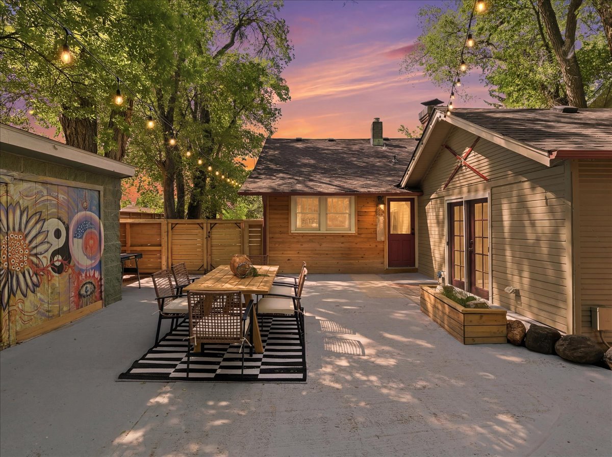 Backyard entertaining area with mature trees at 1726 W Mulberry Fort Collins