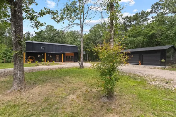 feature image of Motorsports Enthusiast’s Dream Estate in Orange, TX — Striking Modern Black Exterior Featuring 4 Bedrooms, 2 Baths, a Spacious 3-Car Garage, Gated Driveway Access, and Exceptional Indoor-Outdoor Livin