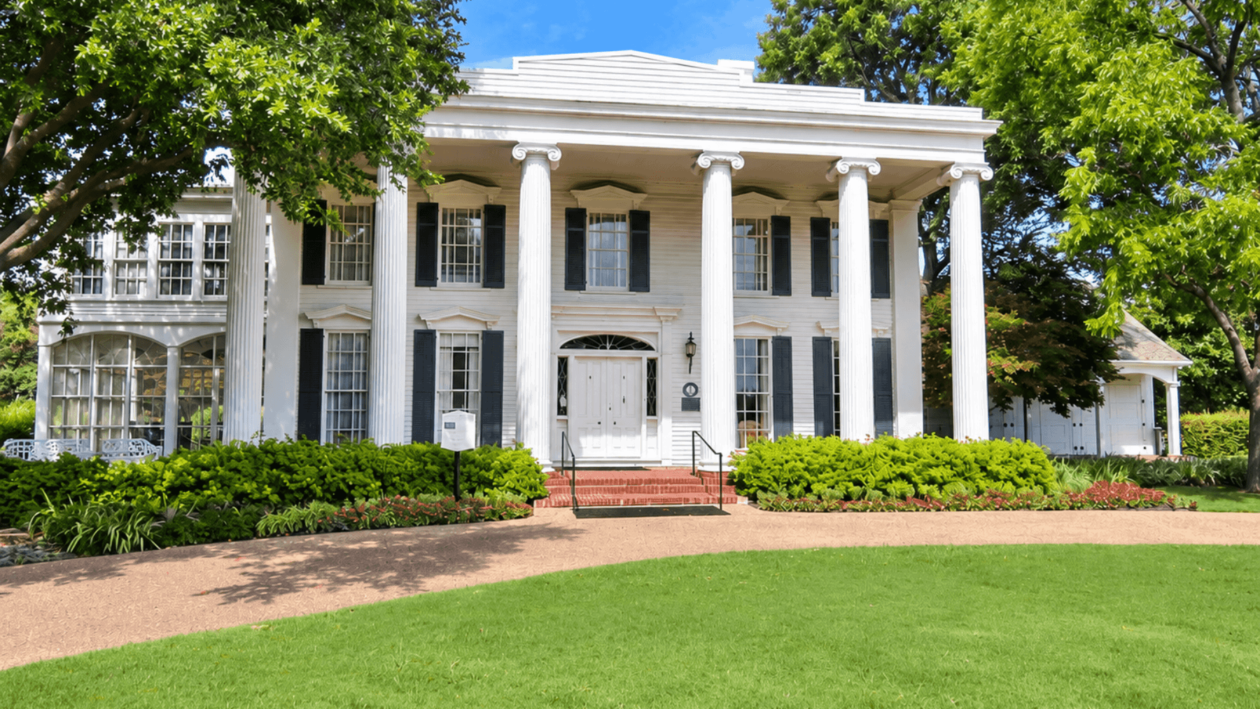 Historic Caruth Homeplace in Dallas with its white columned façade, representing the farmland and history behind modern North Dallas