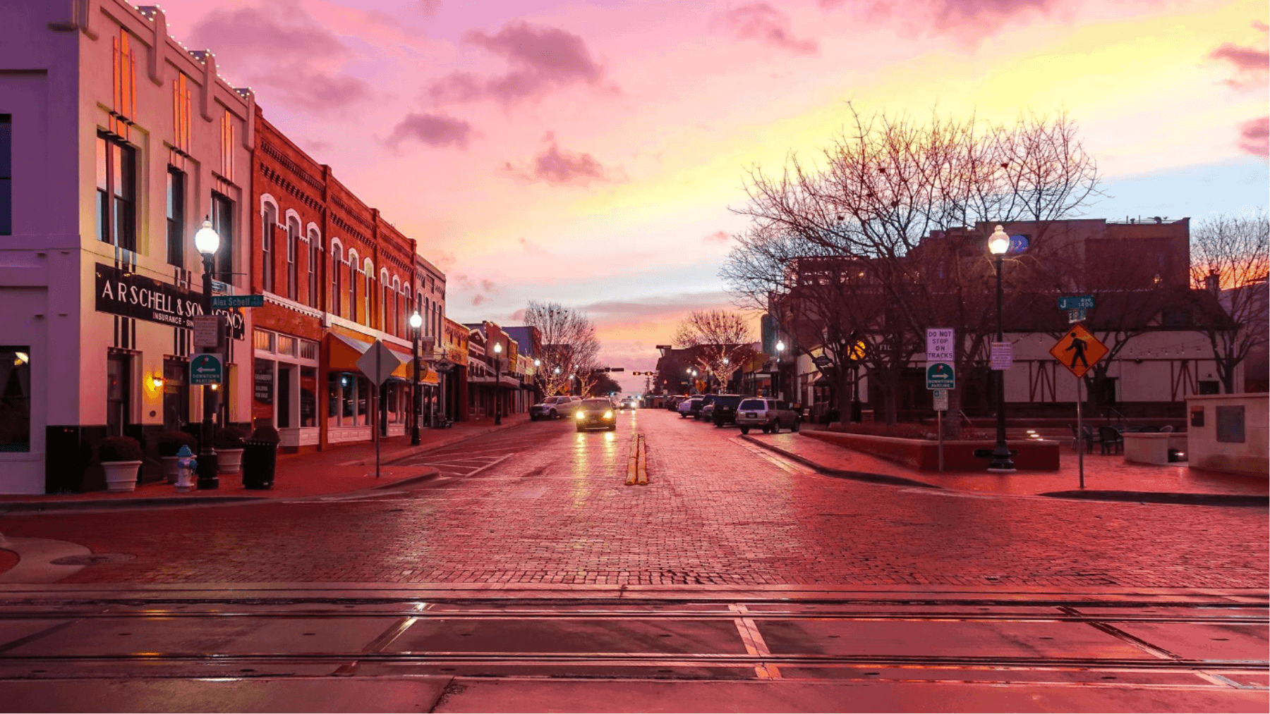Historic Downtown Plano, Texas, with brick streets and storefronts, representing the devastating fires that shaped and rebuilt the city’s downtown district