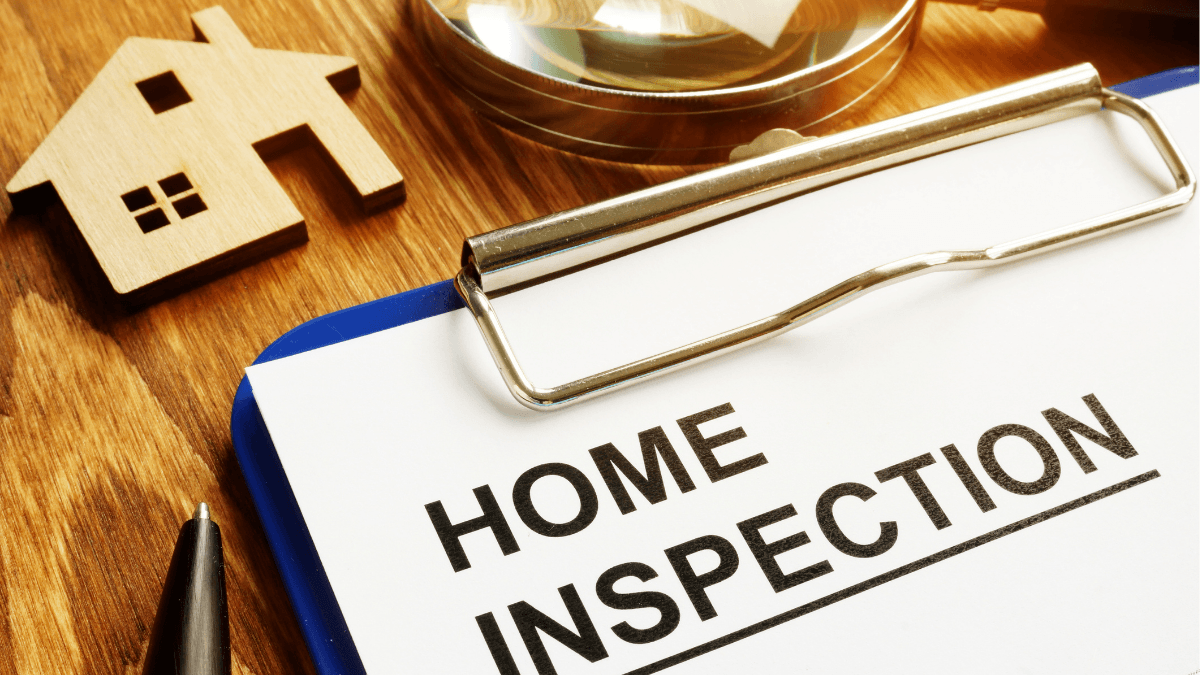 Home inspection report with magnifying glass and house icon representing the importance of inspections for North Texas home buyers