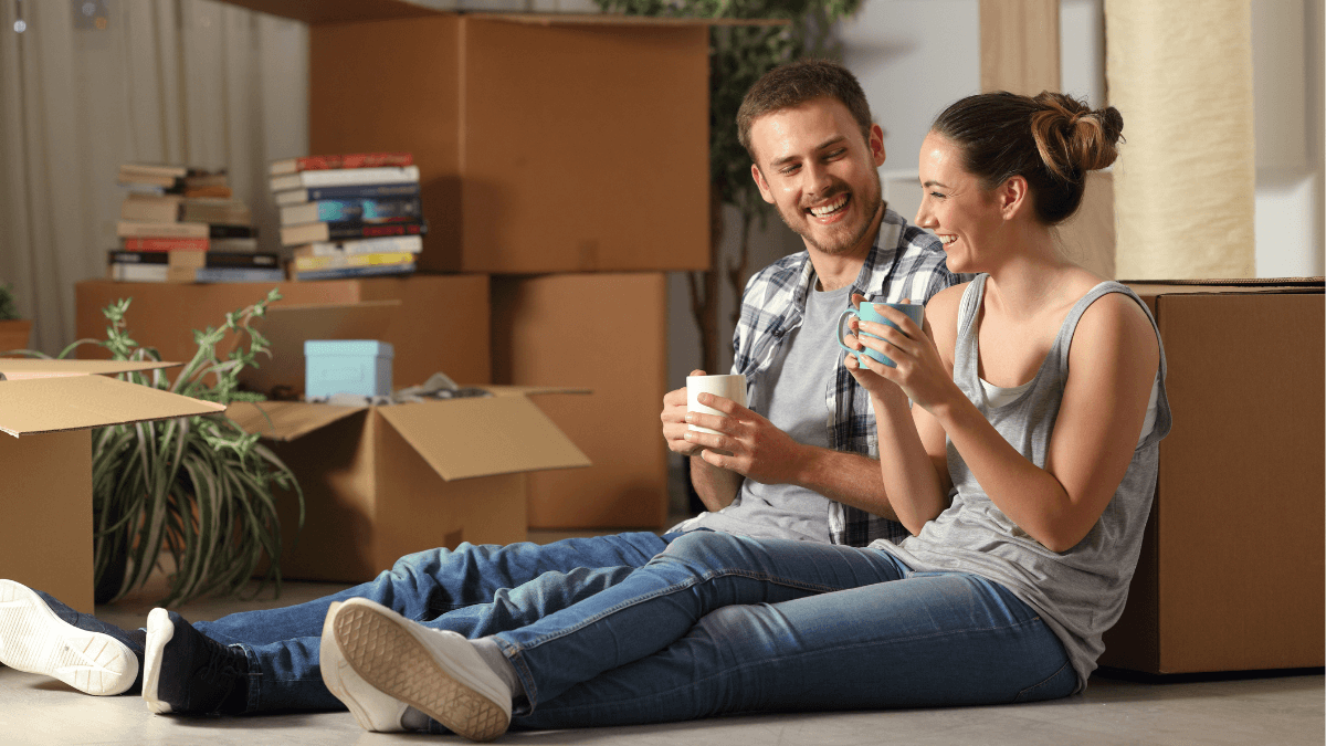 Dallas homebuyers relaxing among moving boxes after going under contract on a home