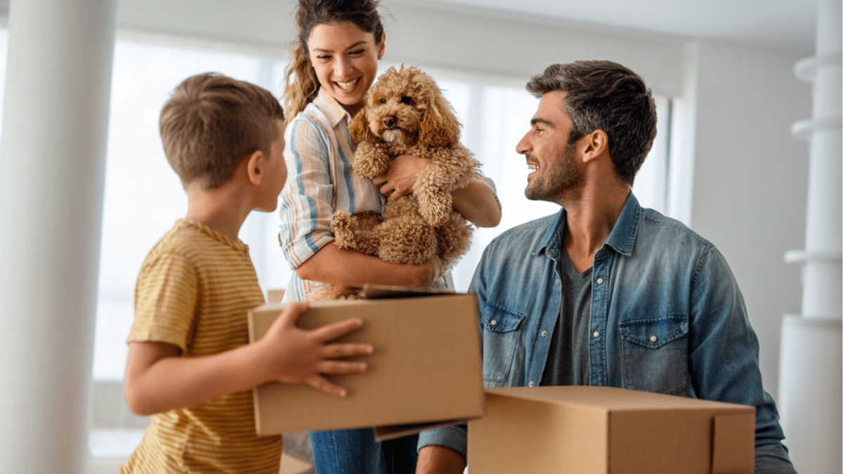 Family moving into a new home with boxes, illustrating how seller concessions can help Dallas home buyers with closing costs and upfront expenses