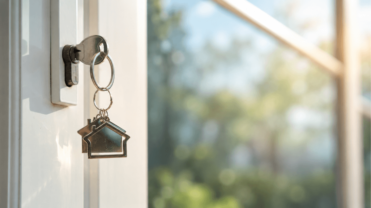 House keys in a front door lock, representing strategic timing for Dallas-area home sellers and the importance of choosing the right day to list a home for maximum buyer visibility