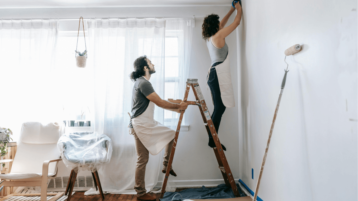 Homeowners painting and preparing a room before listing, illustrating value-boosting home maintenance and pre-sale improvements for Dallas and North Dallas sellers