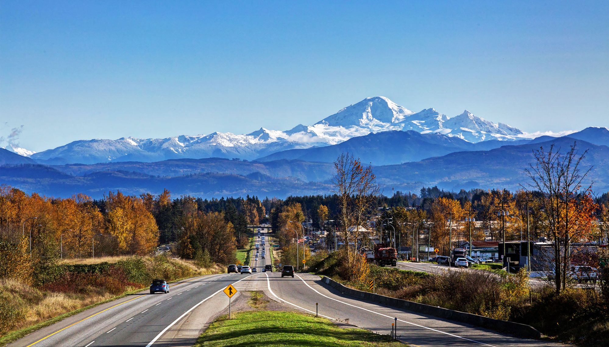 “Scenic view of Abbotsford, BC with mountains, farmland, and city landscape – a vibrant community in the Fraser Valley”