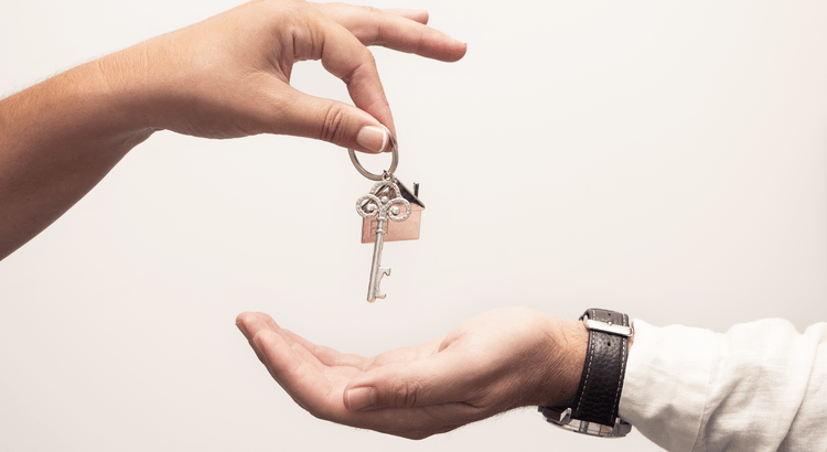 Buying a home in North San Diego County with house keys being handed to a new homeowner