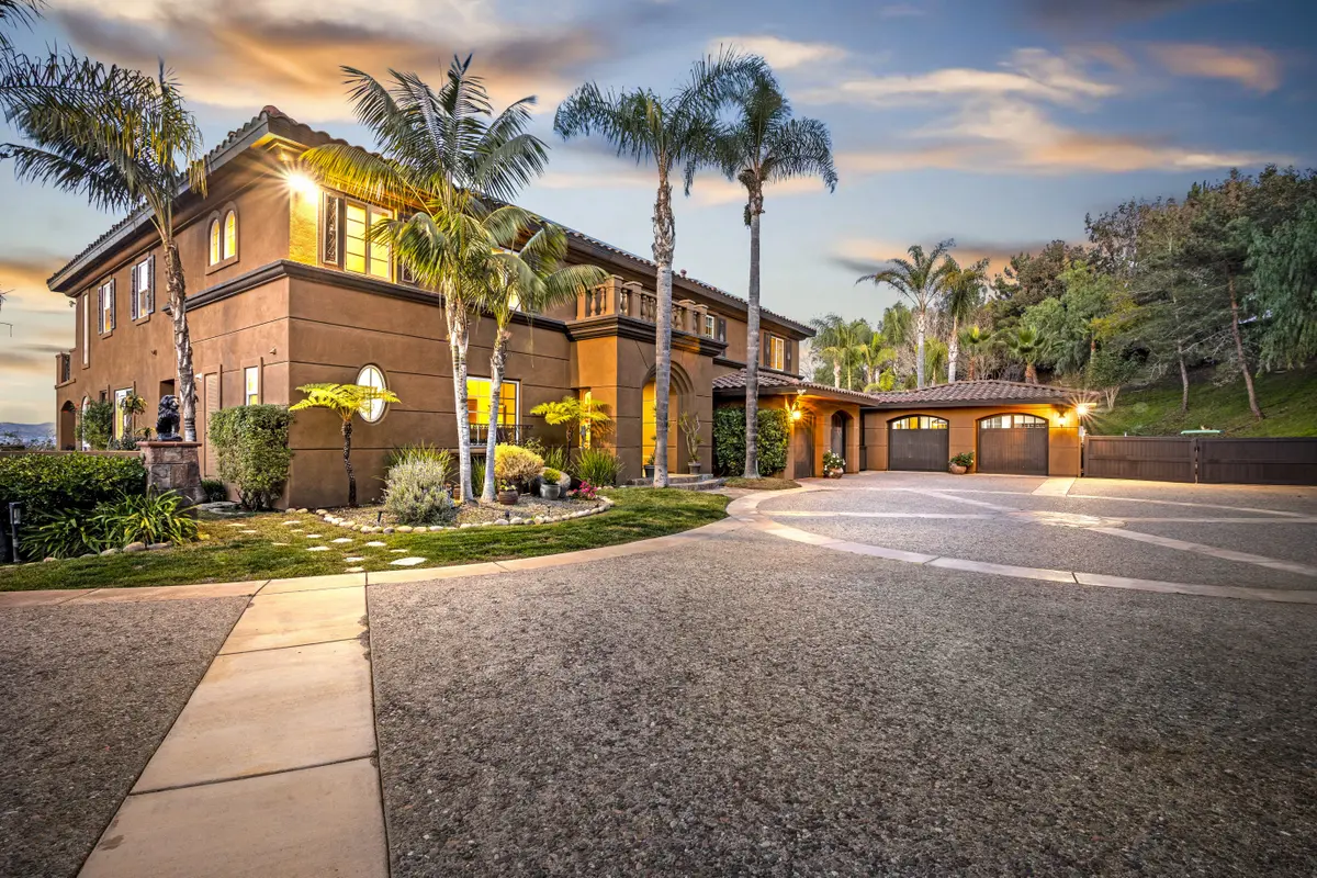 Elegant front exterior of 38061 Villa Toscana in Bonsall, a luxury estate sold by Realtor Patricia Villanueva, featuring Mediterranean architecture and beautifully landscaped grounds.