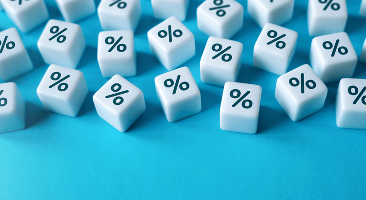 White percentage cubes on a blue background symbolizing mortgage rate changes and interest rate trends in North San Diego County real estate.