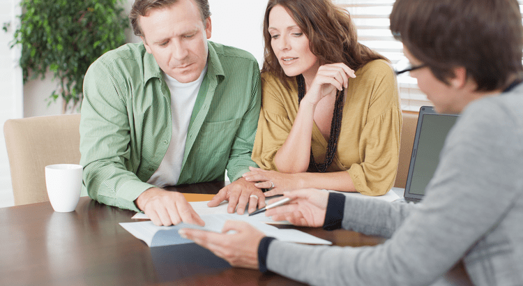 Realtor assisting a couple with buying a new home and selling their current one in San Diego, CA real estate market