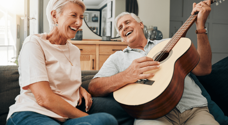 Smiling senior couple relaxing at home together, representing the freedom of being mortgage-free and downsizing in San Diego County.