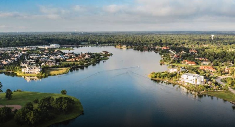 Sunset over Lake Woodlands with restaurants along the waterfront