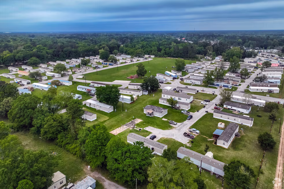 Aerial view of New Caney Texas showing neighborhoods, green space, and surrounding development