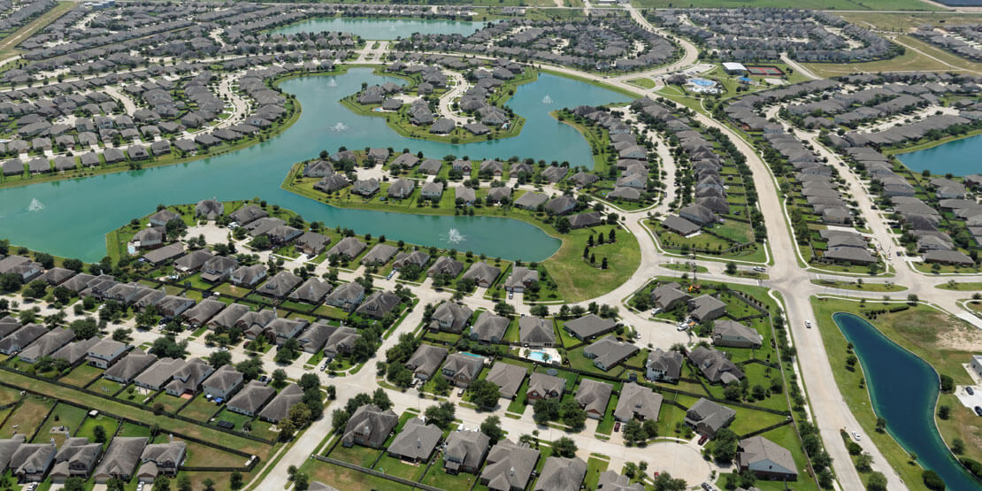 Aerial view of Bridgeland master-planned community in Cypress Texas with lakes and trails.