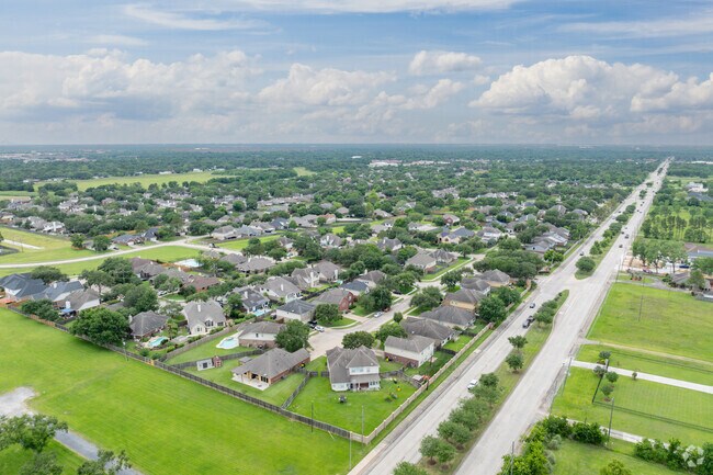Aerial view of established homes and tree-lined streets in Oakbrook Estates in Pearland, Texas