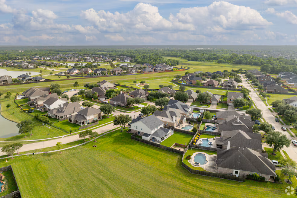 Aerial view of homes, lakes and green space in The Lakes at Highland Glen in Pearland, Texas