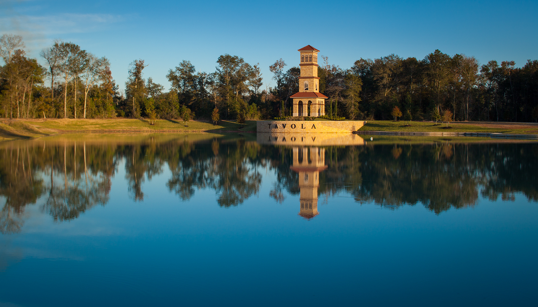 l view of Tavola master-planned community in New Caney, Texas featuring wooded greenbelts, lakes, and modern homes