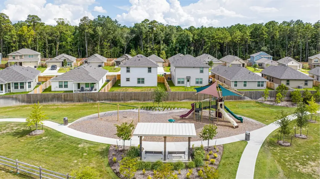 Neighborhood streets and homes in The Canopies community in New Caney, Texas with parks, pool and walking trails