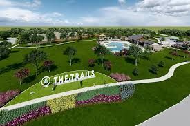 Homes and green space inside The Trails community in New Caney, TX showcasing nature trails and residential streets