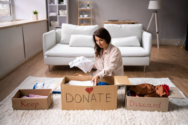A seller decluttering, staging, or consulting with an agent