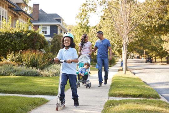 Family walking on a sidewalk in a safe Katy TX neighborhood