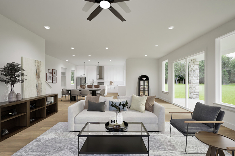 Bright neutral living room with updated lighting in Houston home