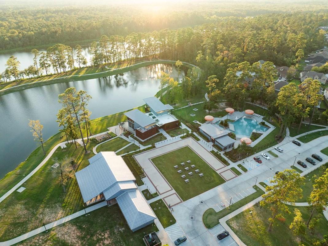 The Lake House amenity center and lakes in Grand Central Park, a master-planned community in Conroe, Texas.