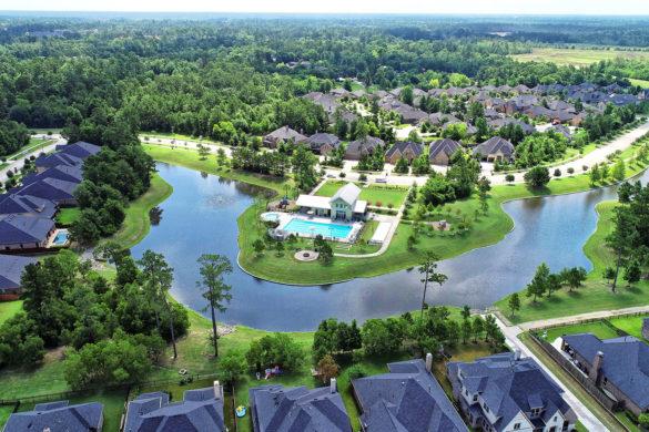 Wooded entrance and community lake in Harper's Preserve near Conroe, Texas.