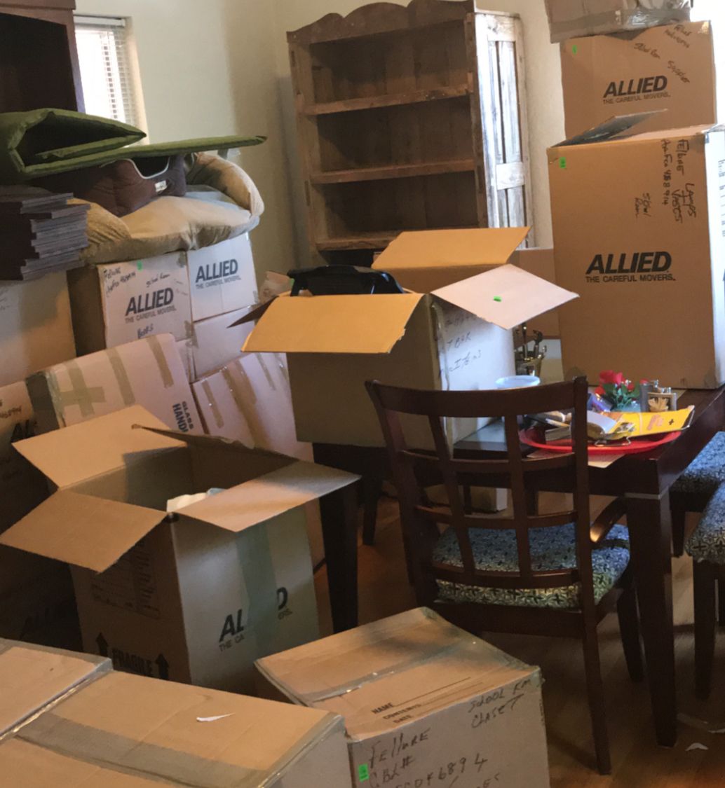 moving boxes in our living room JBSA Sam Houston