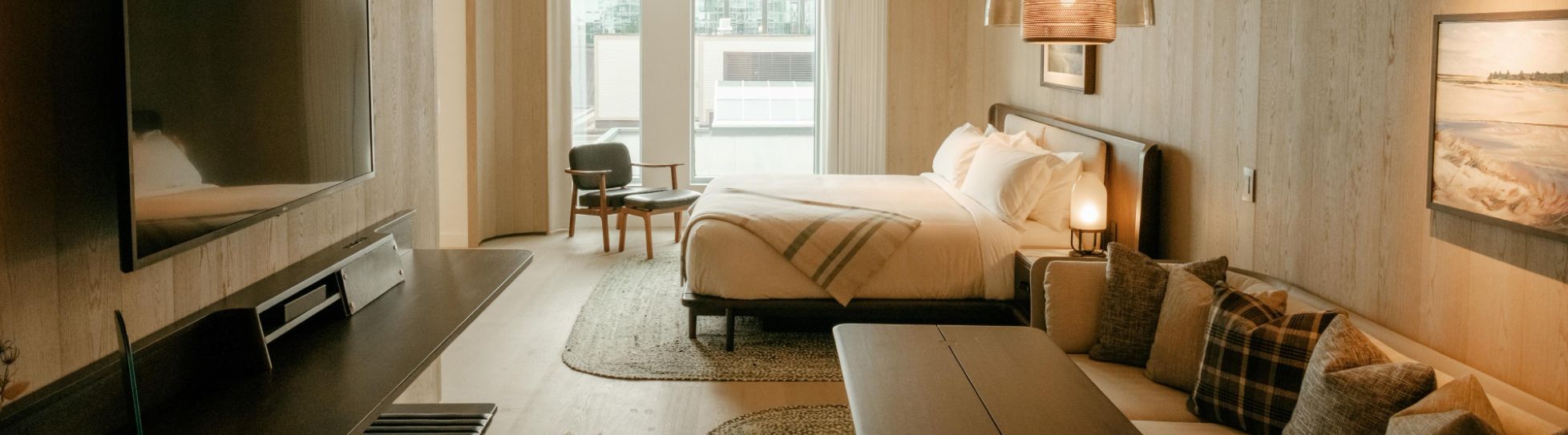 Staged Halifax bedroom with neutral bedding and soft lighting.