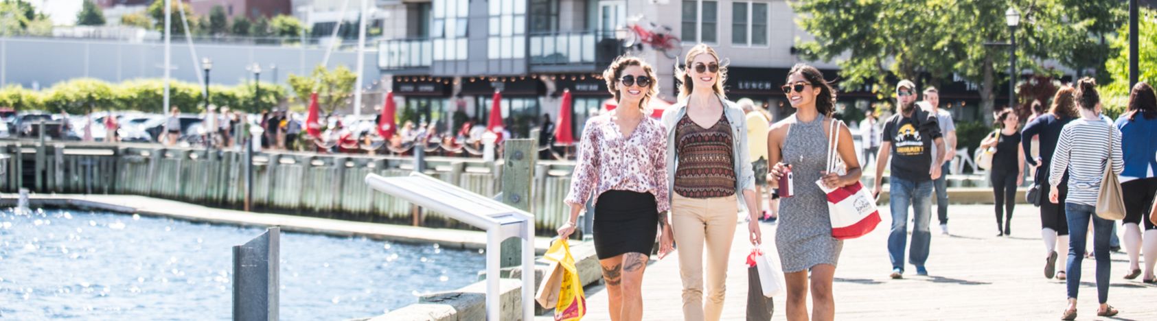 Young professionals walking along the Halifax waterfront boardwalk.