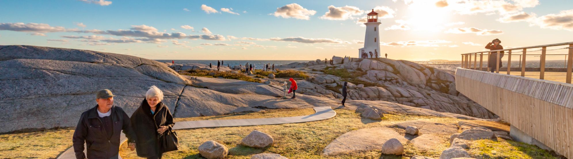 Halifax coastline with rocky shores and waves hitting the shore at sunset.