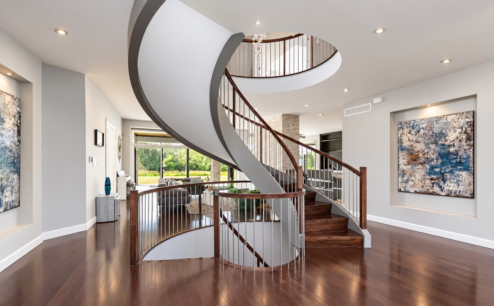 Spacious luxury home interior featuring a sweeping curved staircase and multiple levels, illustrating fire safety considerations for larger homes