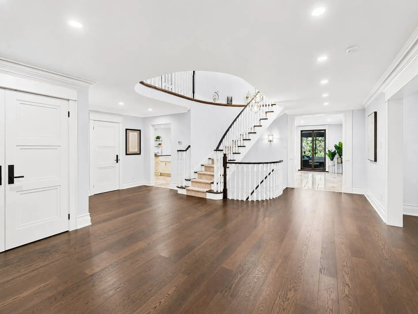 Open main-floor foyer with curved staircase at 816 Norwick Road