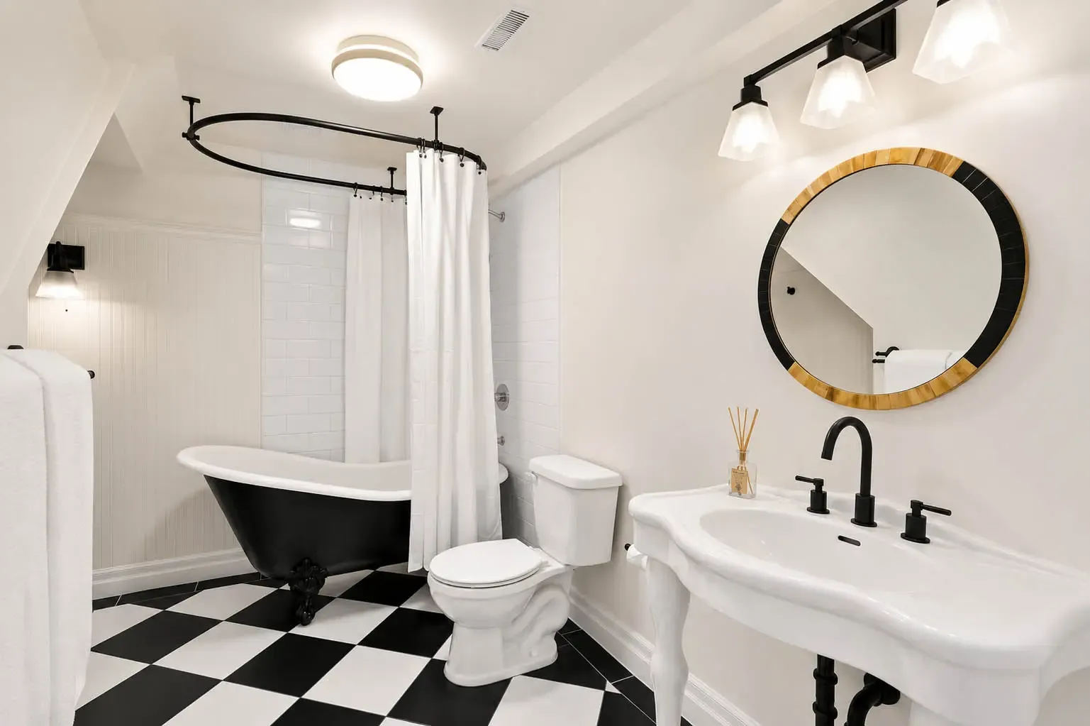 Bathroom with black clawfoot tub and checkerboard floor at 816 Norwick Road