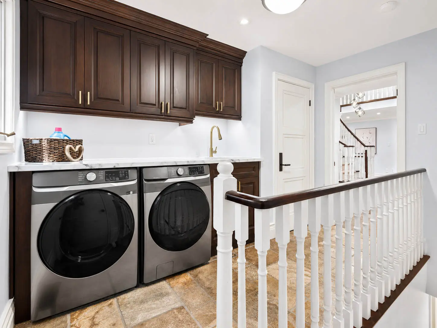 Upper-level laundry area with custom cabinetry at 816 Norwick Road