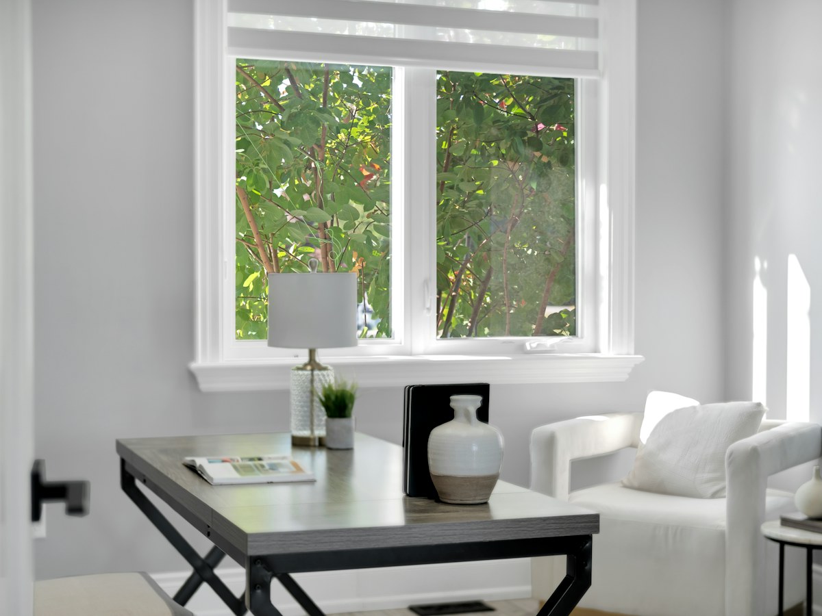 A bright home office with a desk, chair and window