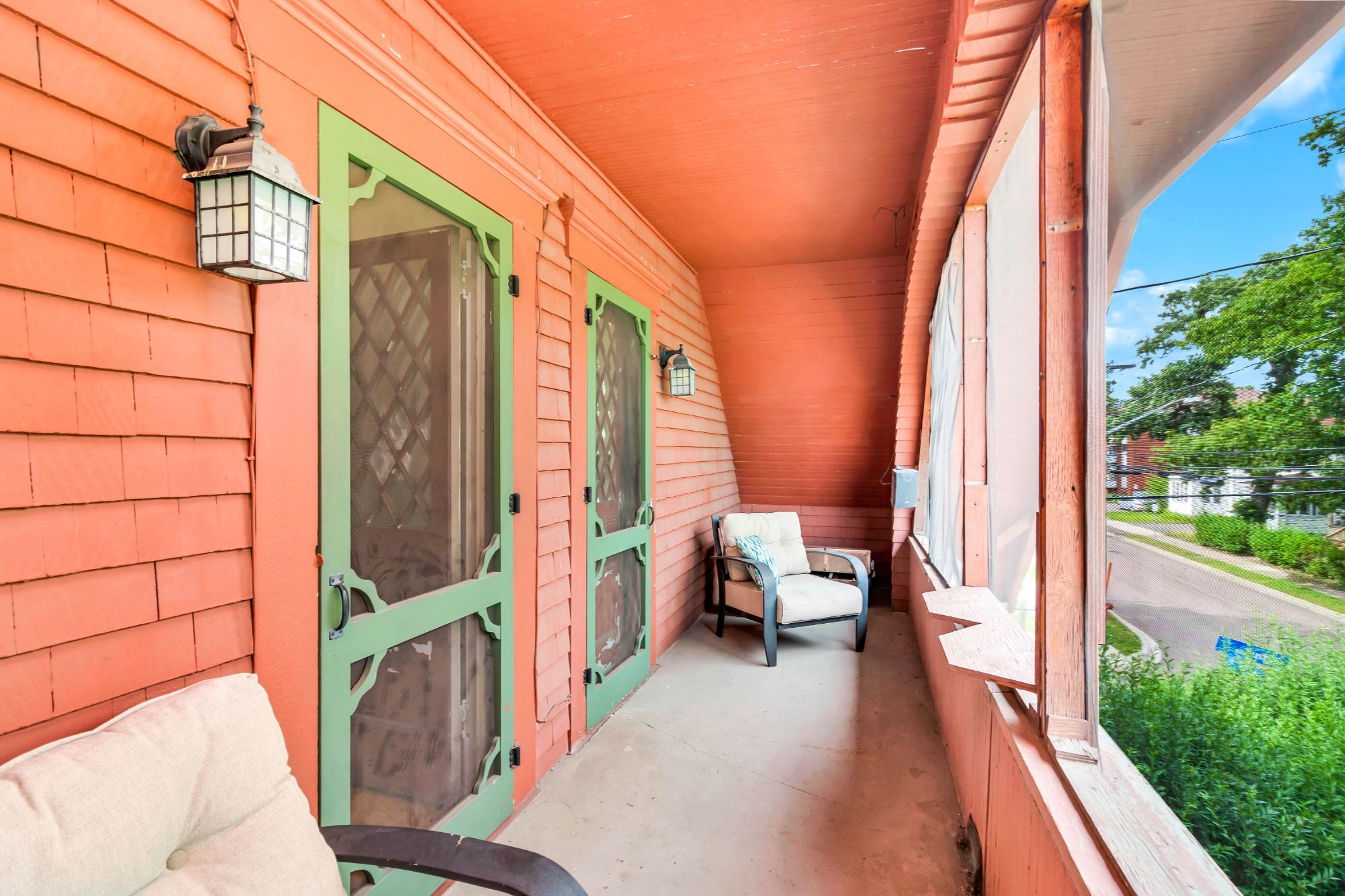 Second-floor screened room at 134 Church Street Moncton with diamond lattice screen doors and original cedar ceiling