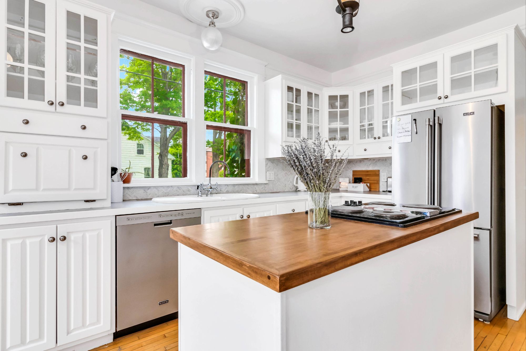Chef-inspired kitchen at 134 Church Street Moncton with white cabinetry, butcher block island and large windows
