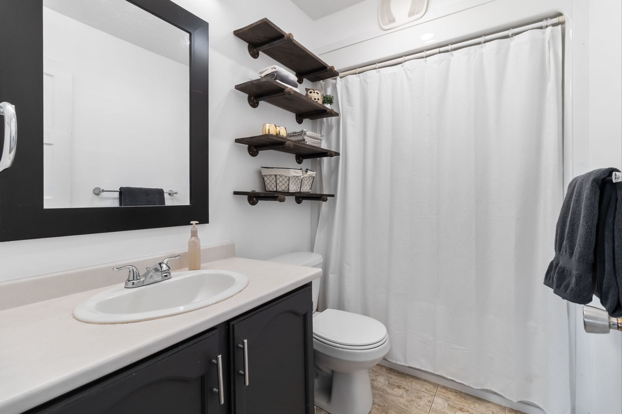 Updated Bathroom with Dark Vanity - 27 Airport Street Dieppe NB